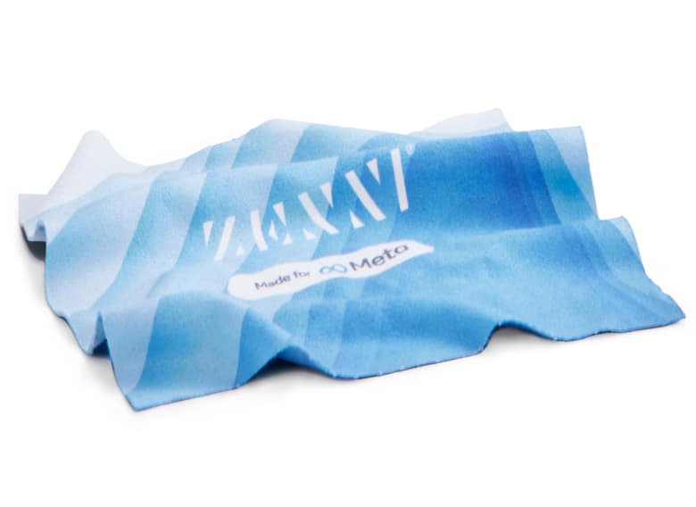 Microfiber lens cloth with Zenni Optical and Meta branding. The cloth is different shades of blue with a wave pattern.